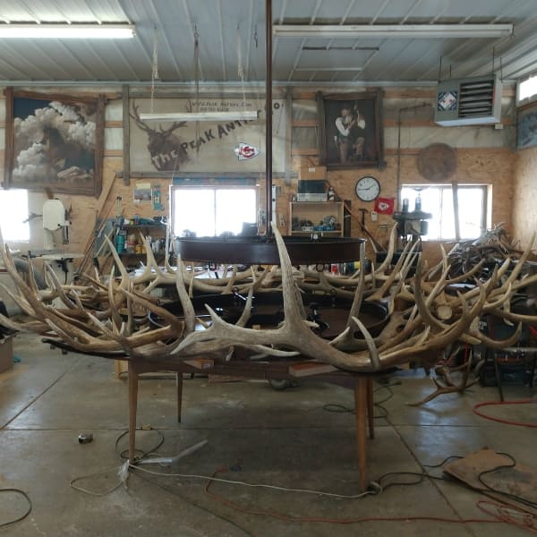Iron base of large custom antler chandelier being built