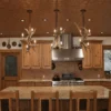 three mule deer antler pendant lights over a home kitchen island