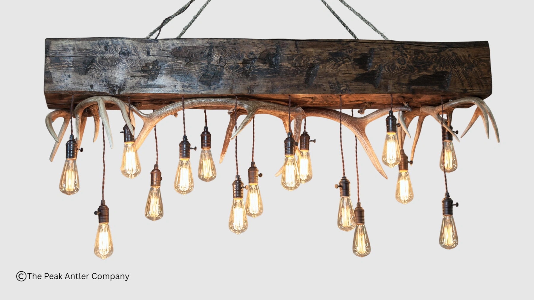 a large timber chandelier with whitetail deer antlers and elk anters