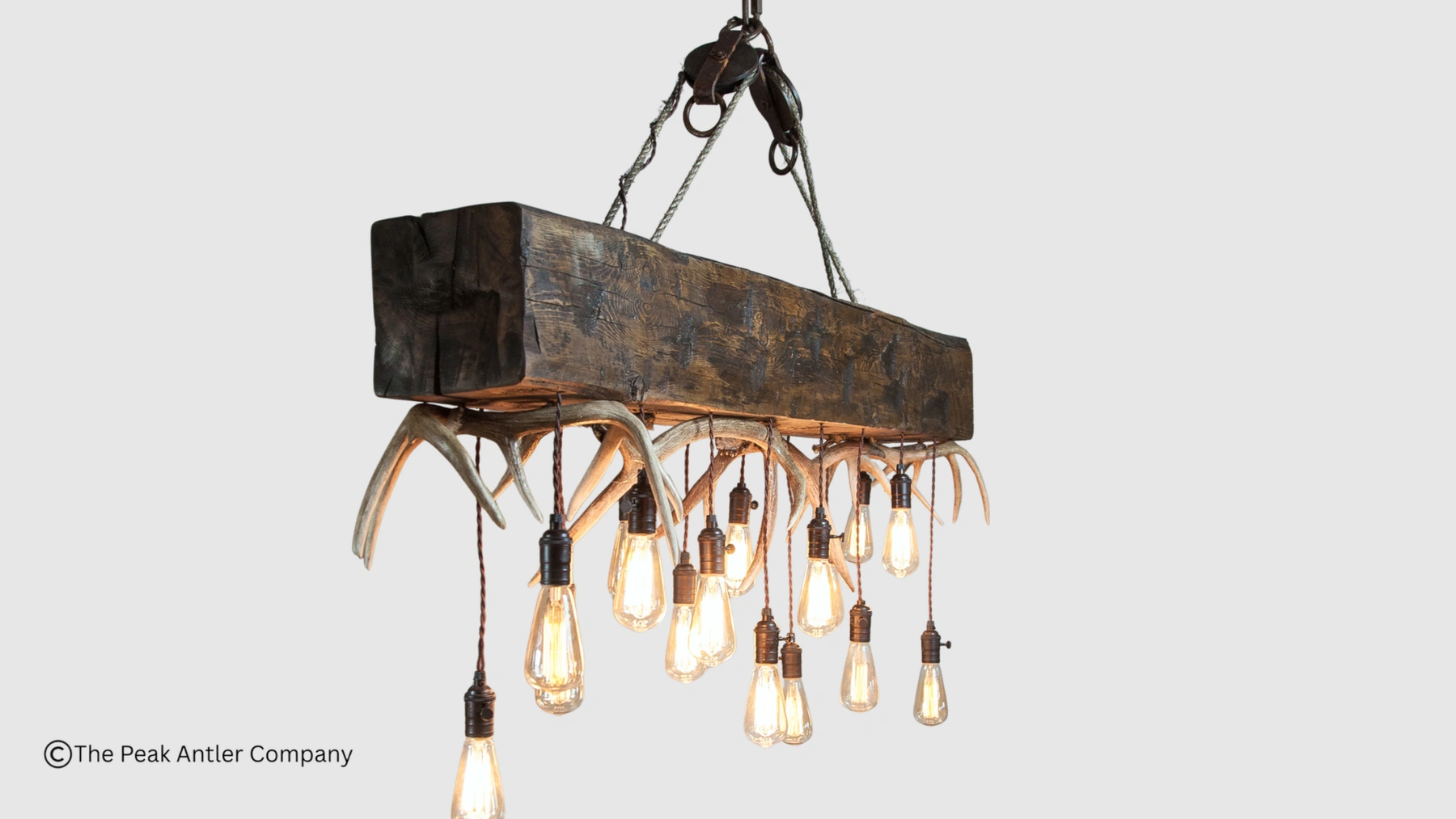 elk and whitetail deer antler chandelier with a timber over the top