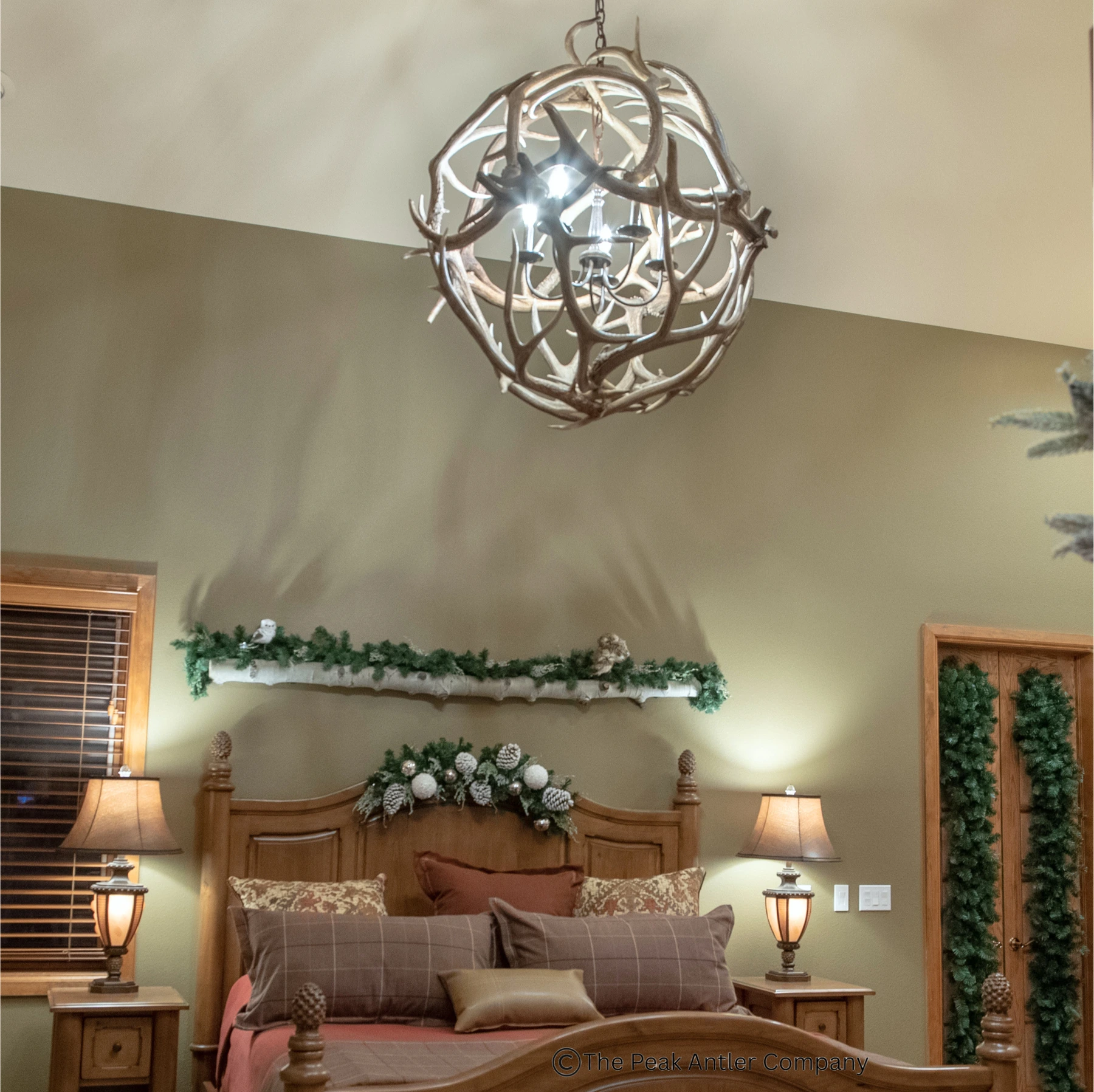 elk antler globe in a home bedroom over the master bed