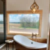 Mule Deer antler globe pendant light in a home master bathroom over the bathtub