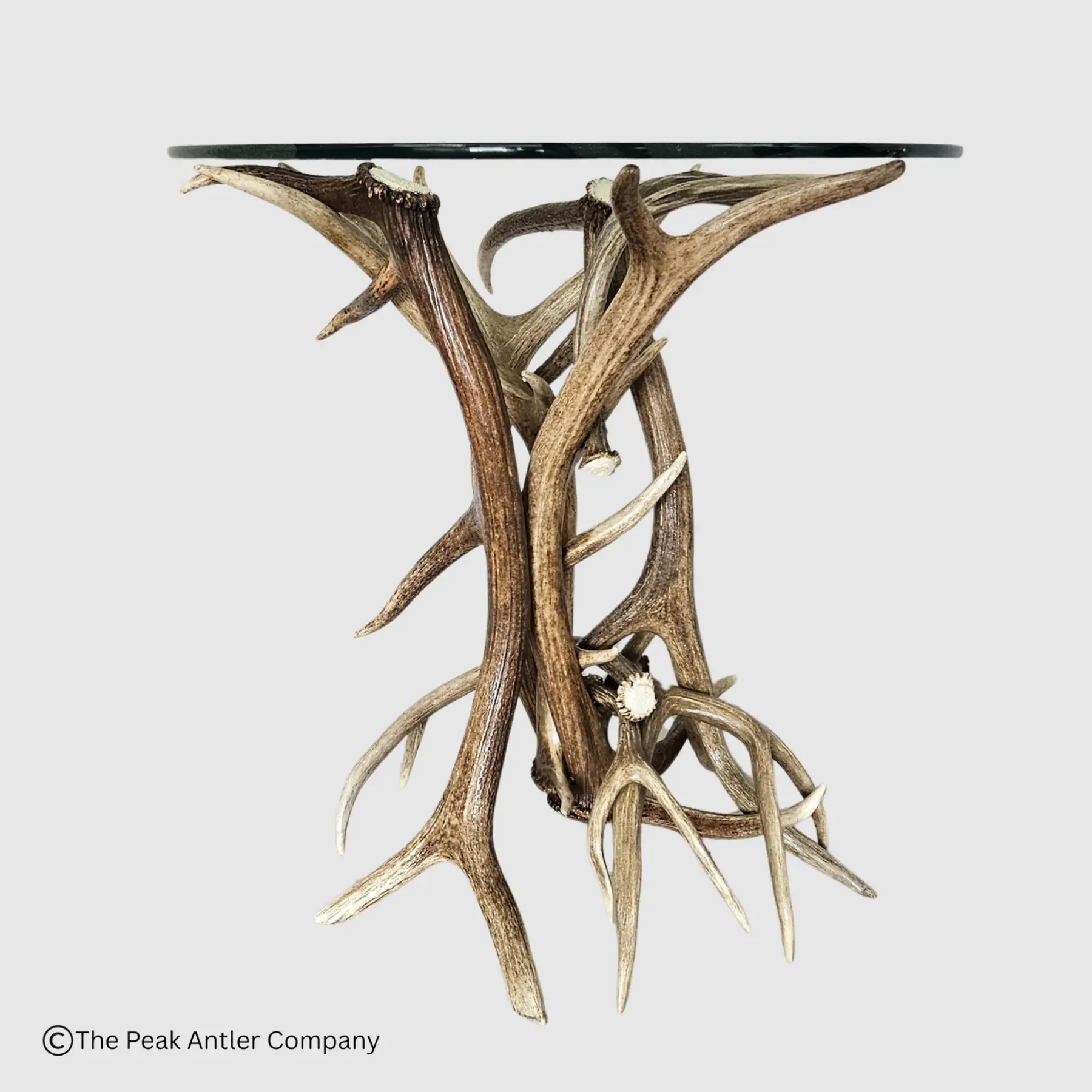elk and mule deer antler end table with a round glass top