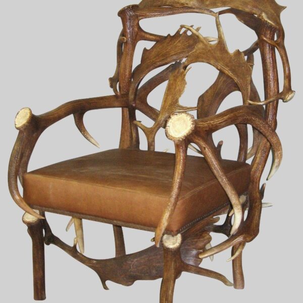 elk and fallow deer chair with brown leather cushion