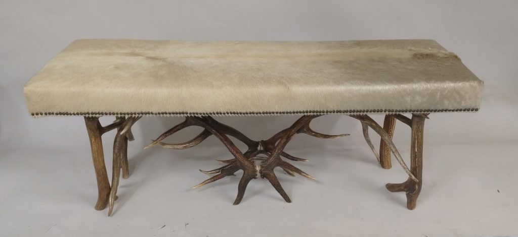 elk bench with white cow hide
