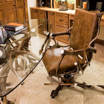 antler desk and rolling chair in home office