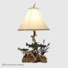 mule dee antler table lmap with a wooden base and hand forged metal fishing scene