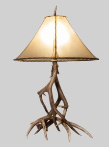 large mule deer table lamp with a natural rawhide lamp shade light on