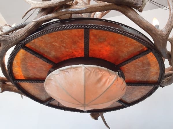 bottom view of large mt bross elk chandelier with a rawhide and mica dome base