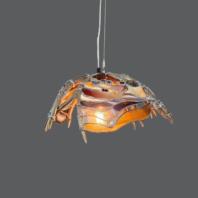 stained glass antler pendant light with agates and fossils added into the design
