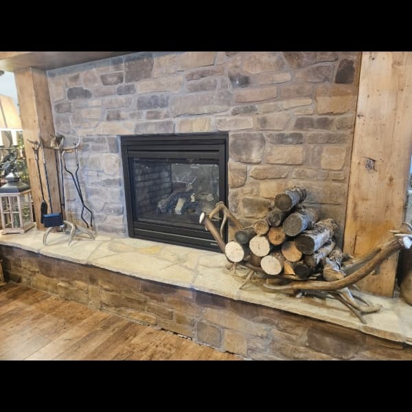 in home picture of the elk and mule deer antler half round log rack