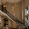 a set of three mt oso mule deer antler chandeliers in a home spiral staircase