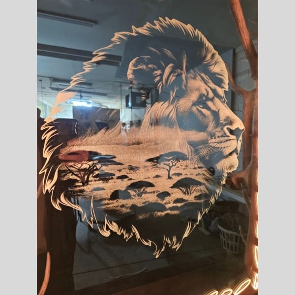 close up of lion details etched into a mirror