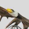 close up of eagle;e face carved into moose antlers
