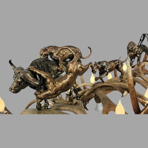 close up of scultpure wildlife scene on elk antler chandelier predator's domain