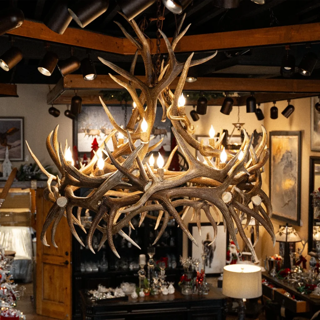 A large, round elk antler chandelier hanging over a large room