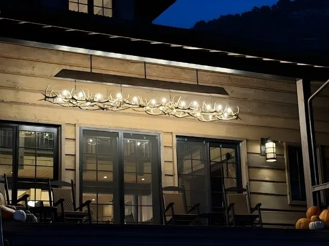 A custom Snowmass antler chandelier on the porch of a Colorado home