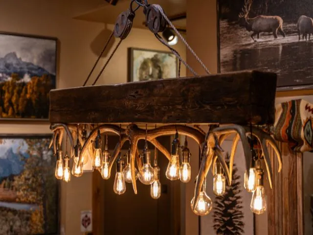 A rustic Timberline Chandelier hanging in the Tweeds showroom in Woodland Park, CO