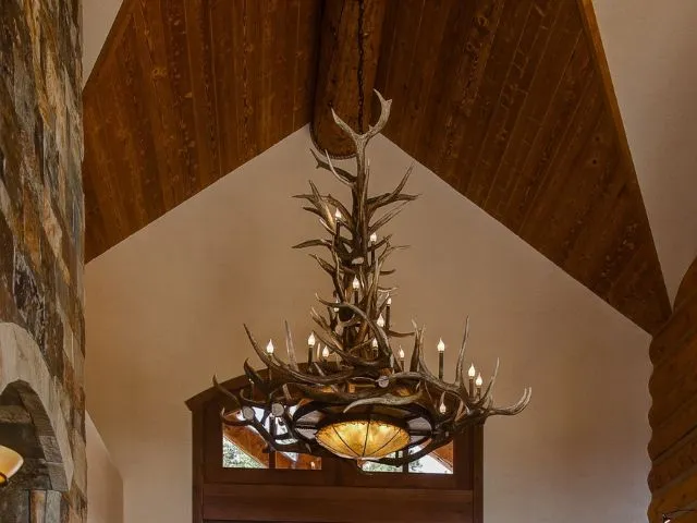 An XL Mt. Bross antler chandelier hanging in a large entry way of a Colorado home