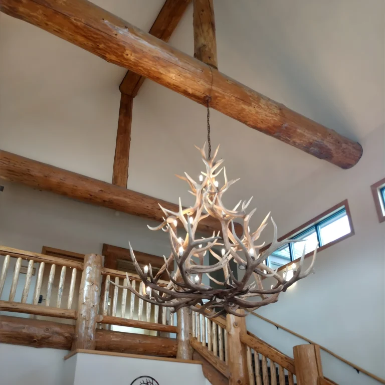 A large deer antler chandelier hanging in a great room