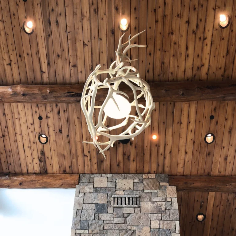 Custom globe antler chandelier hanging in grand room