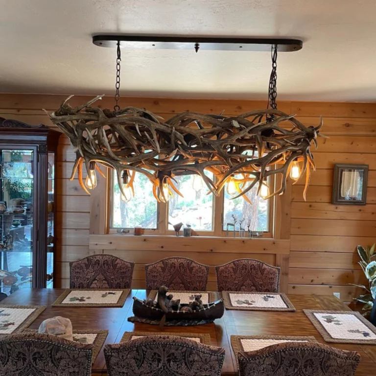 Custom mule deer antler chandelier hanging over dining room table