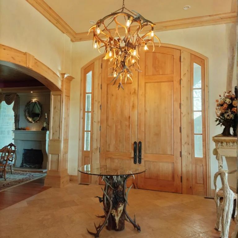 Challenger Peak antler chandelier hanging over custom antler bistro table