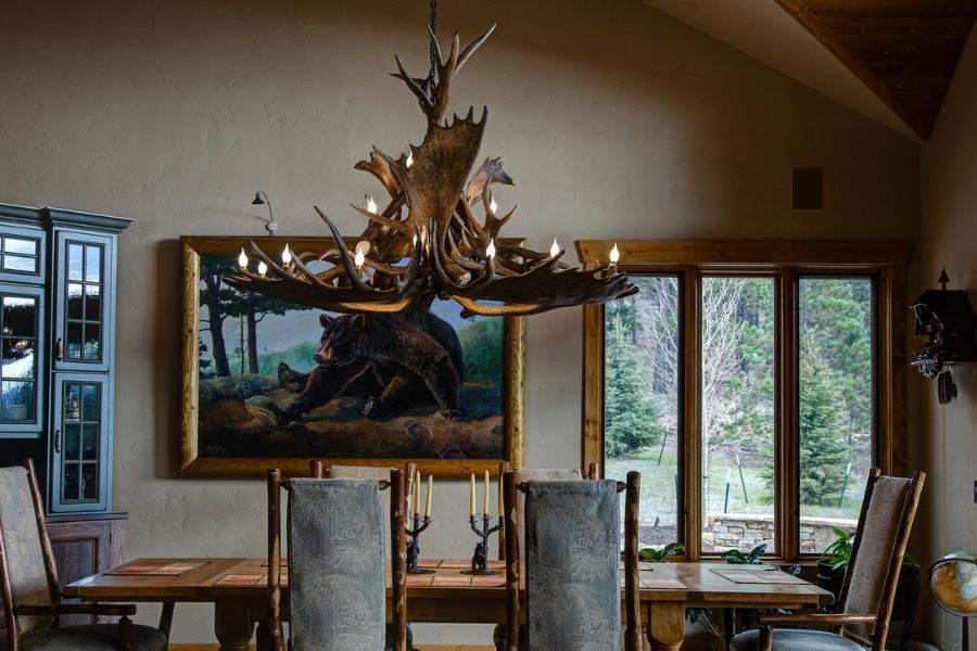Moose Antler chandelier hanging over a dining room table in Colorado